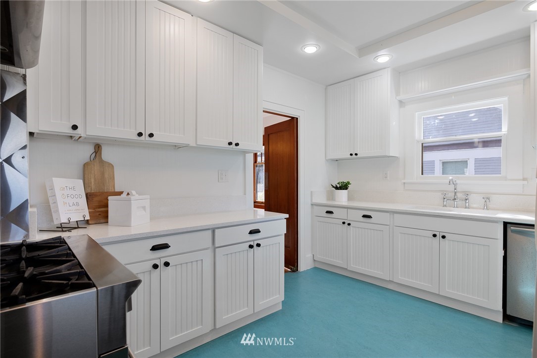 1614 Oakes Avenue Everett, WA 98201 - Photo 7 of 26 a kitchen with white cabinets and appliances