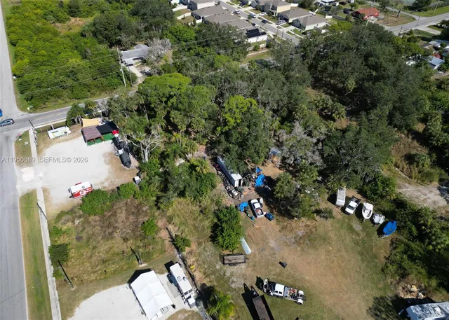 an aerial view of a houses with yard