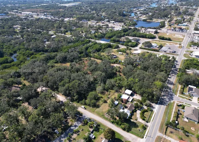 an aerial view of residential house with outdoor space and trees