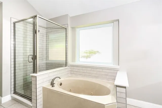 a bathroom with a bathtub and shower
