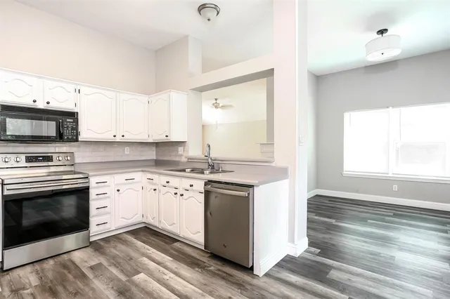 a kitchen with a stove oven and sink