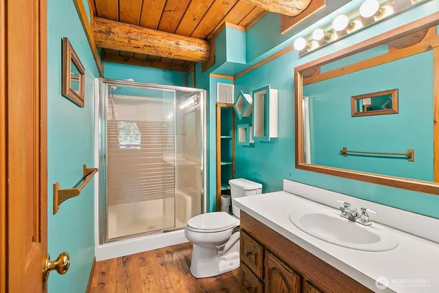 a bathroom with a sink toilet and shower