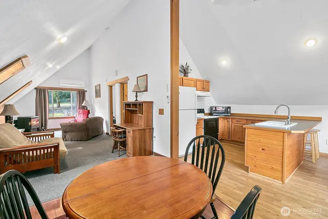 a living room with furniture a flat screen tv and next to a window