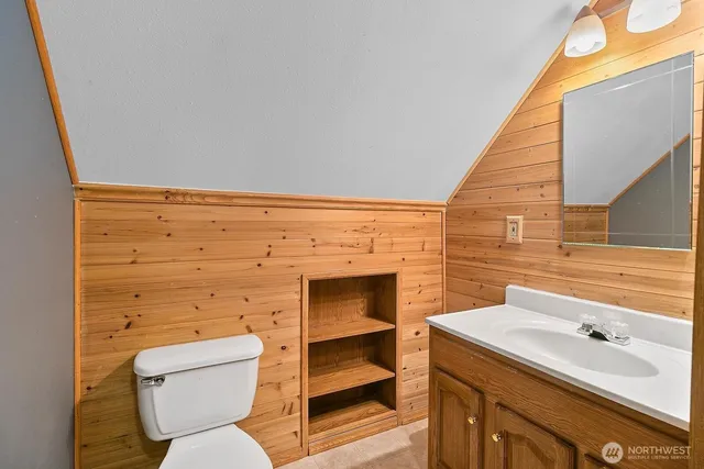 a bedroom with a bed and a flat tv screen on dresser