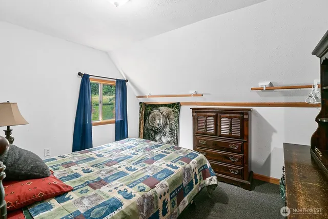 a dining room with furniture and a floor to ceiling window