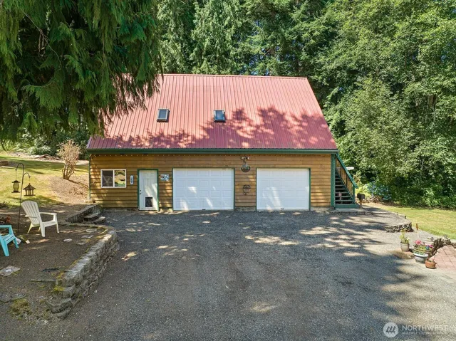 a view of a house with a yard and garage