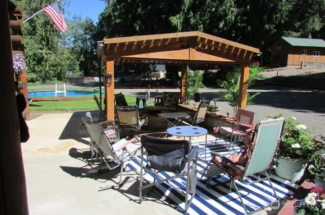 a view of a patio with furniture and a garden
