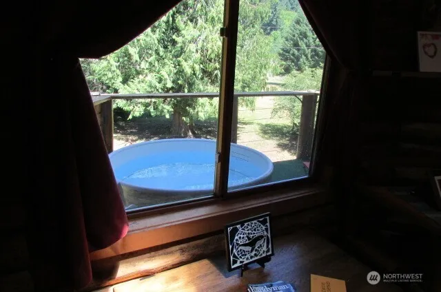 a view of a glass door with a bench in front of it