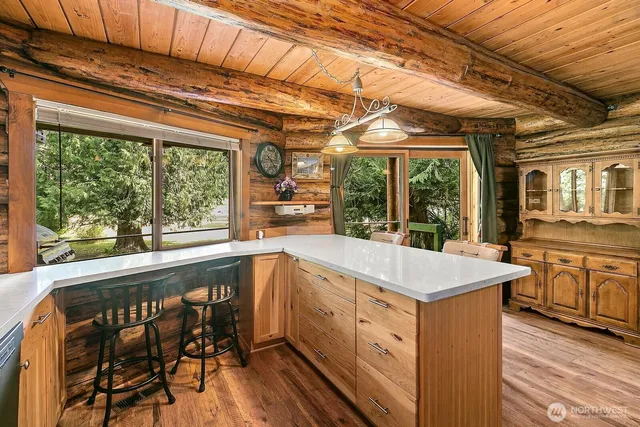 a view of a kitchen with granite countertop a sink and wooden floor