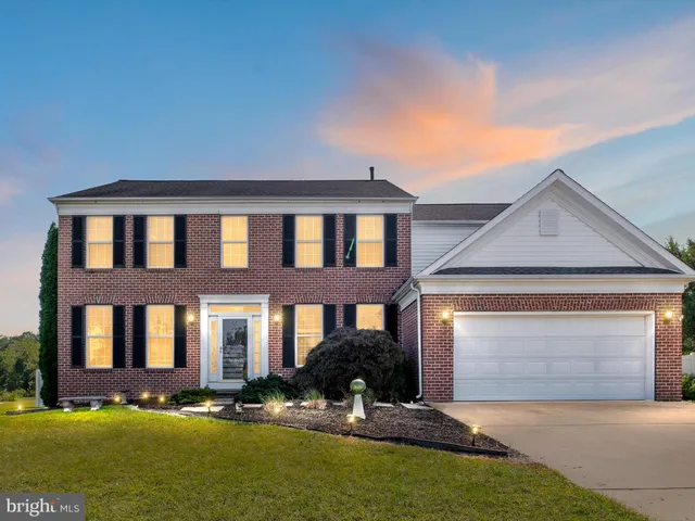 a front view of building with yard and green space