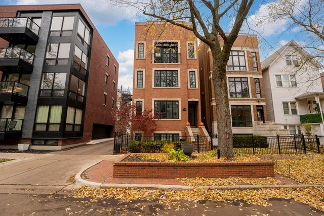 a front view of a building with a garden
