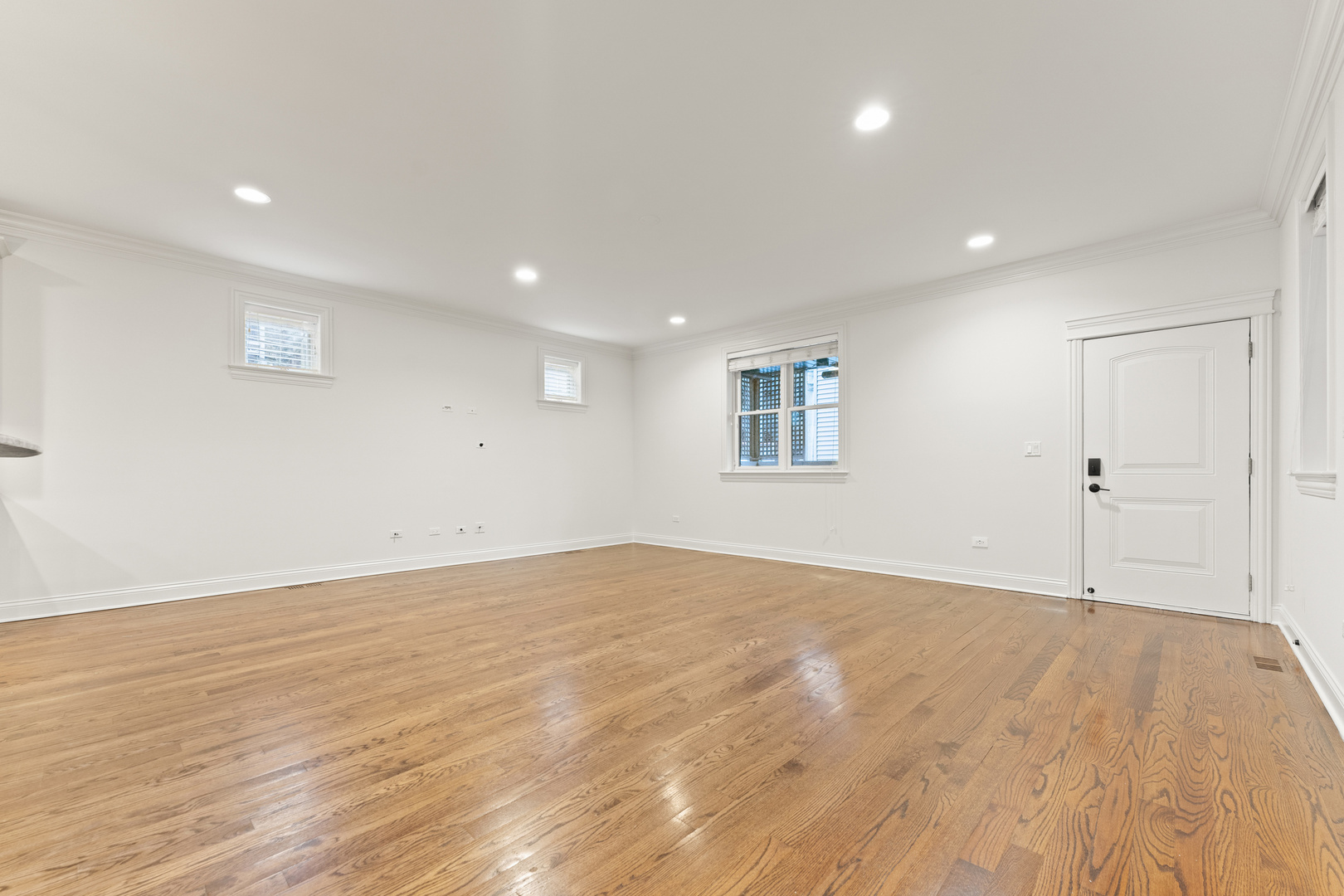 3716 North Kenmore Avenue, Unit 1 Chicago, IL 60613 - Photo 11 of 33 a view of an empty room with wooden floor and a window