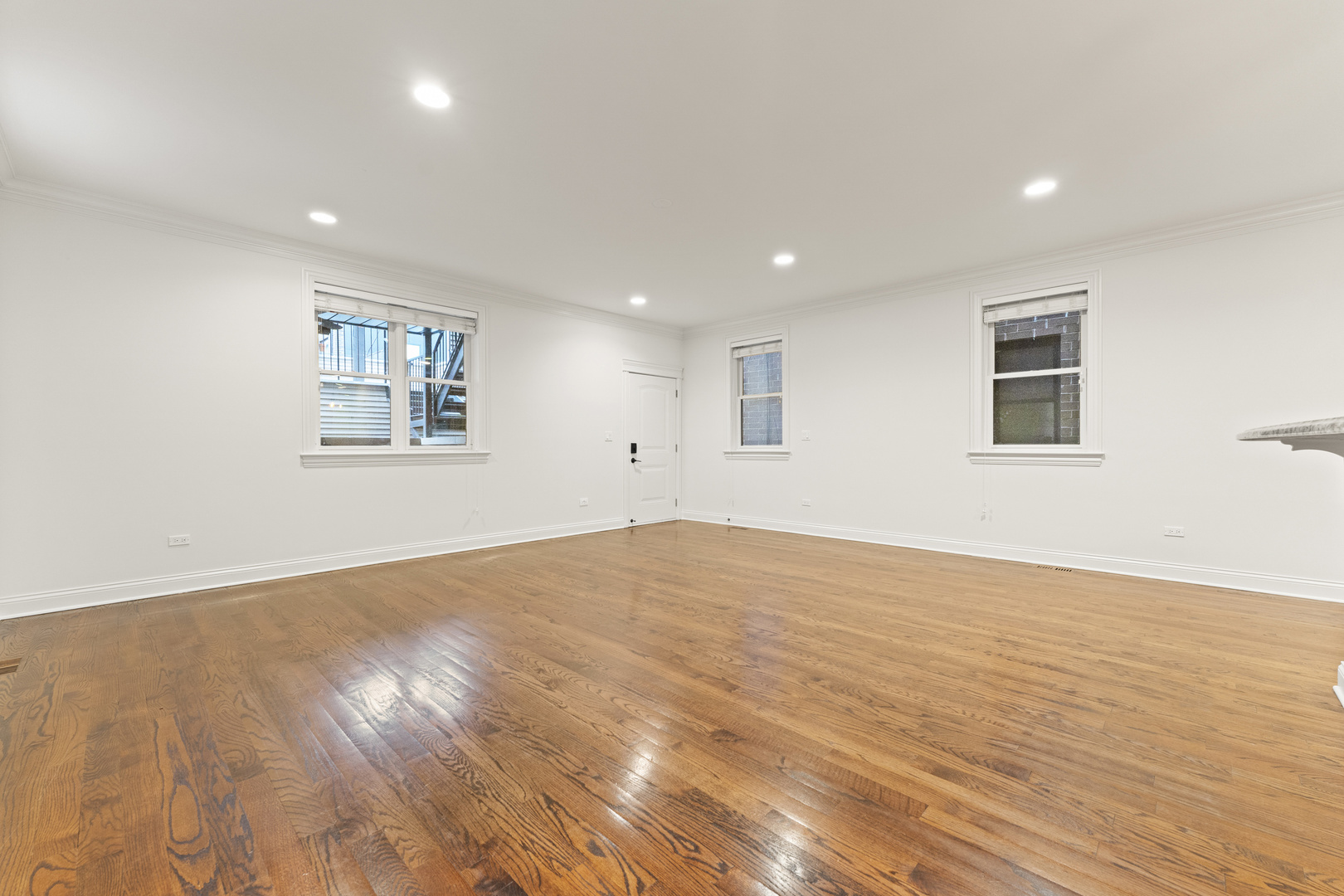 3716 North Kenmore Avenue, Unit 1 Chicago, IL 60613 - Photo 12 of 33 a view of empty room with wooden floor and fan
