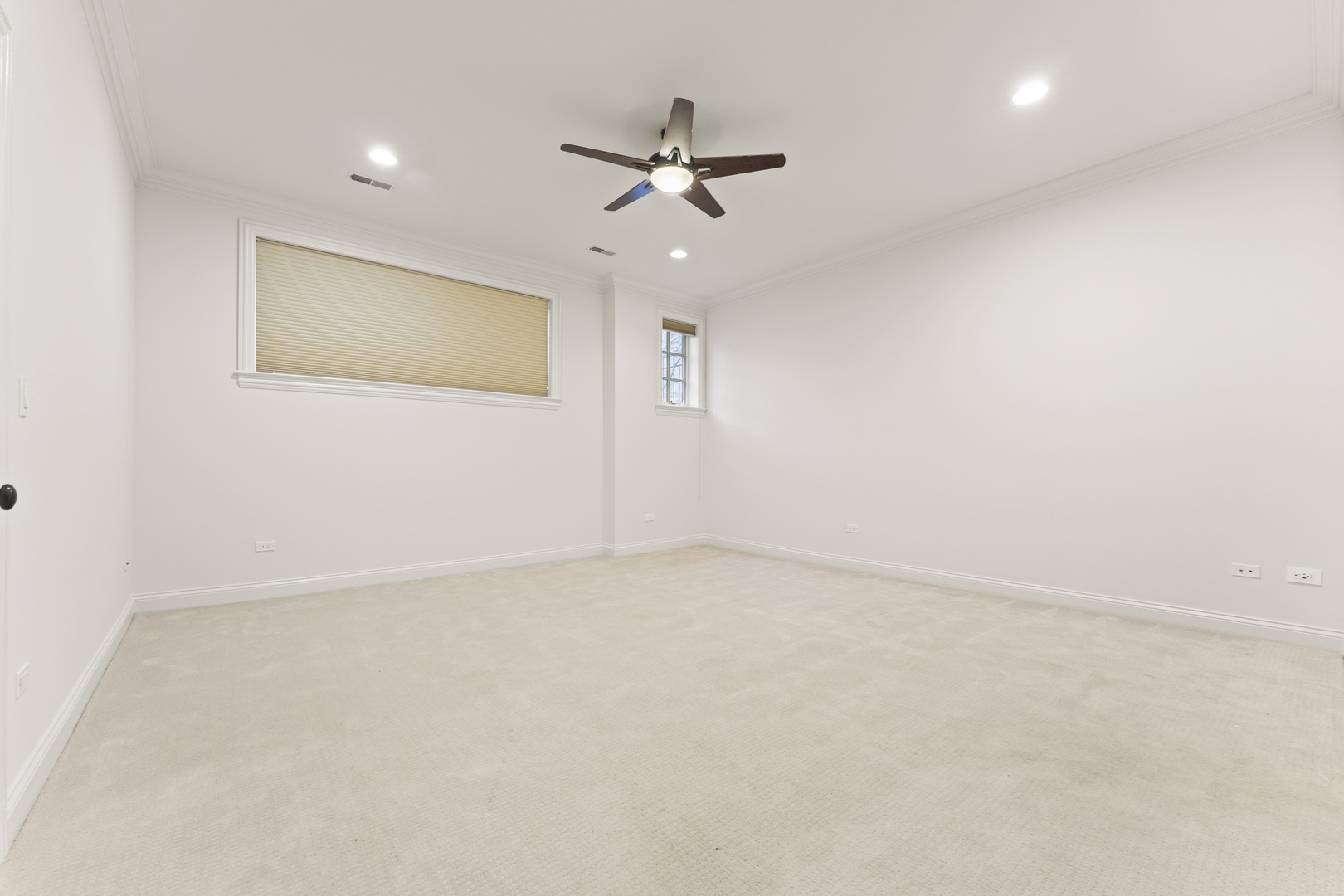 3716 North Kenmore Avenue, Unit 1 Chicago, IL 60613 - Photo 13 of 26 an empty room with a ceiling fan and a window