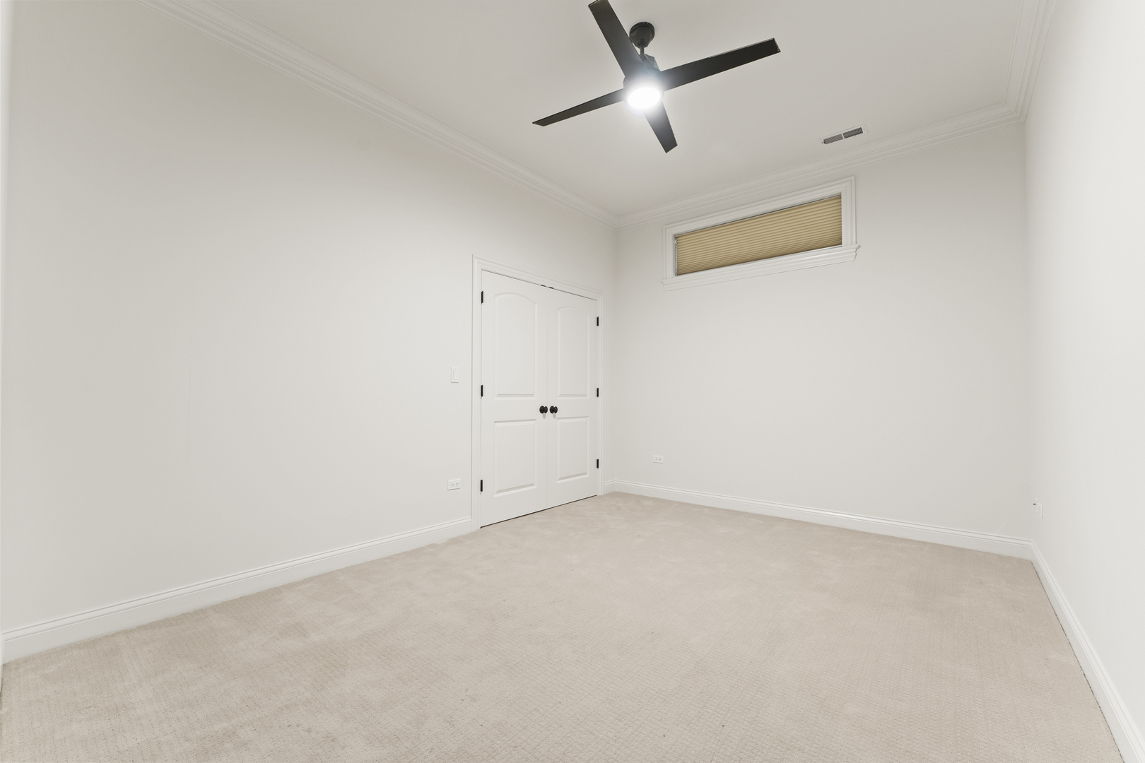 3716 North Kenmore Avenue, Unit 1 Chicago, IL 60613 - Photo 21 of 33 an empty room with a ceiling fan and a window