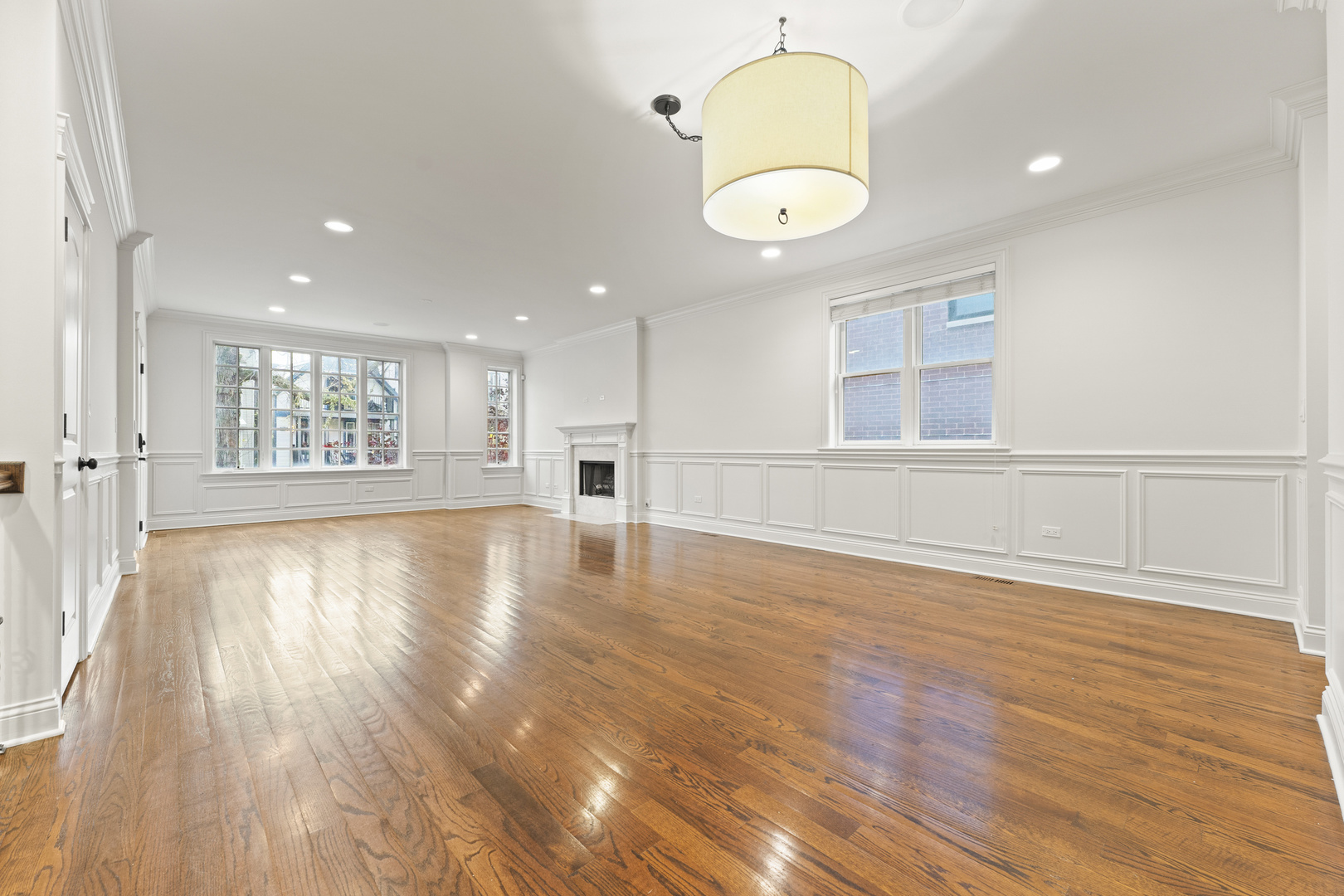 3716 North Kenmore Avenue, Unit 1 Chicago, IL 60613 - Photo 6 of 33 a view of an empty room with wooden floor and a window