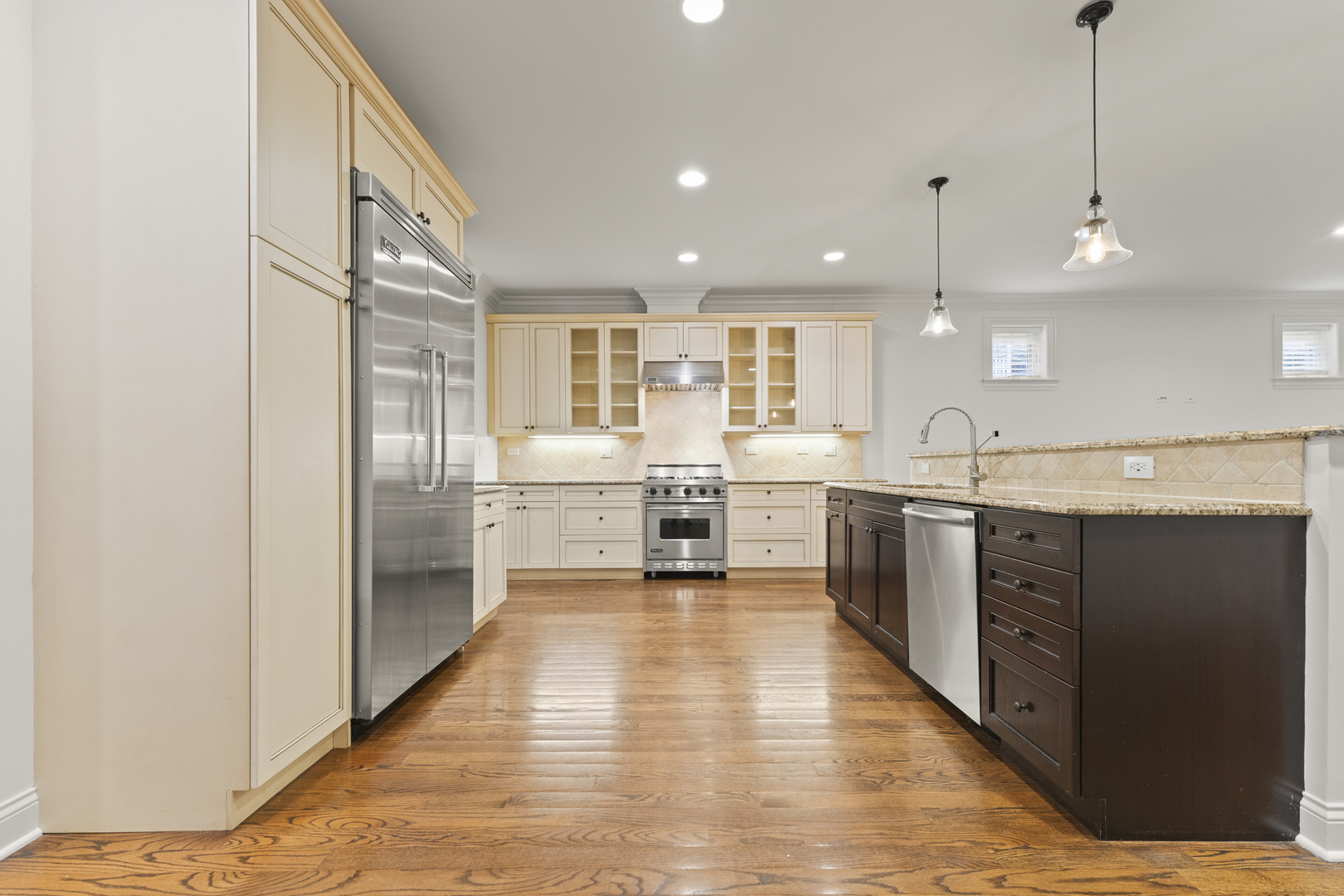 3716 North Kenmore Avenue, Unit 1 Chicago, IL 60613 - Photo 8 of 33 a large kitchen with stainless steel appliances kitchen island granite countertop a large cabinets a sink and a refrigerator