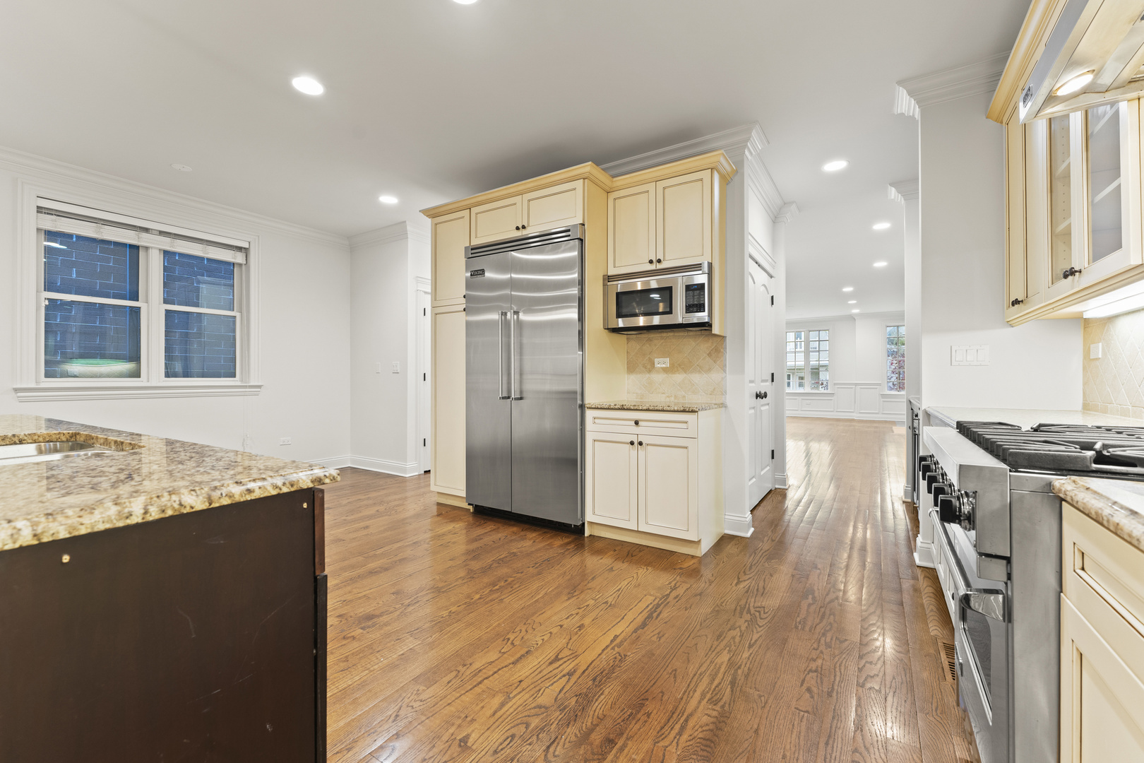 3716 North Kenmore Avenue, Unit 1 Chicago, IL 60613 - Photo 10 of 33 a kitchen with stainless steel appliances granite countertop a refrigerator a stove and a wooden floors