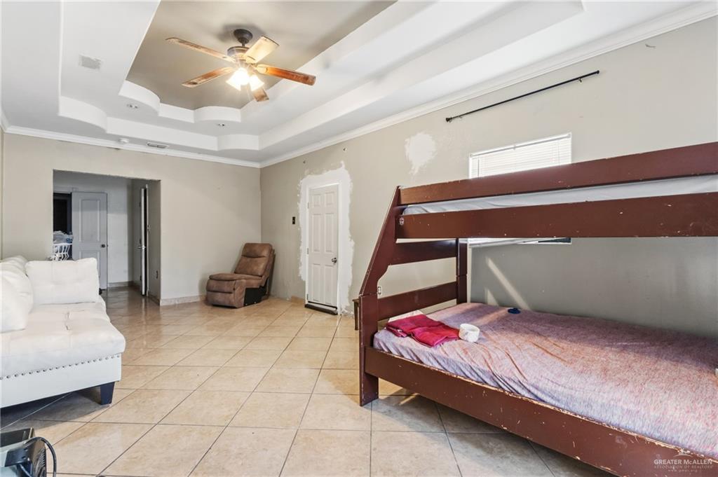 335 Watts Avenue Weslaco, TX 78596 - Photo 13 of 15 a bedroom with furniture and a chandelier