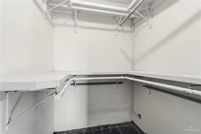 a bathroom with a tub a sink and a large mirror