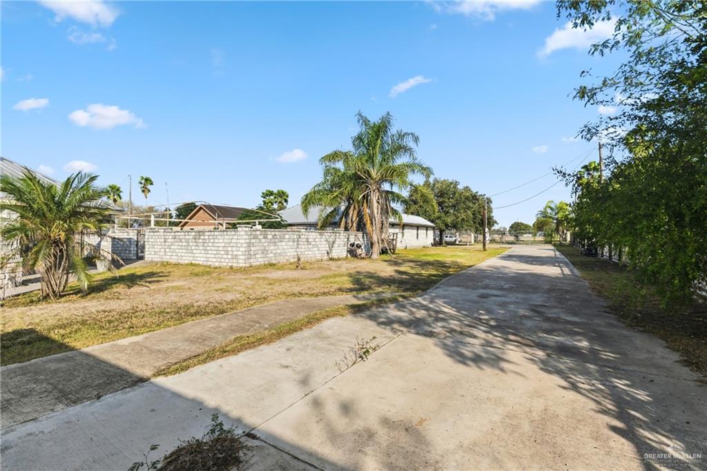 335 Watts Avenue Weslaco, TX 78596 - Photo 3 of 15 a view of a yard with palm trees