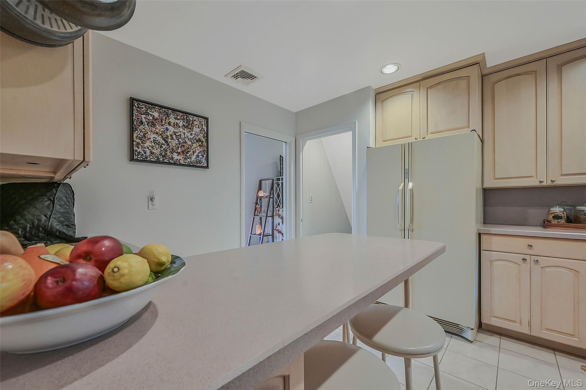 746 Sound View Road Mill Neck, NY 11765 - Photo 13 of 37 a kitchen with stainless steel appliances kitchen island granite countertop a table chairs and a refrigerator