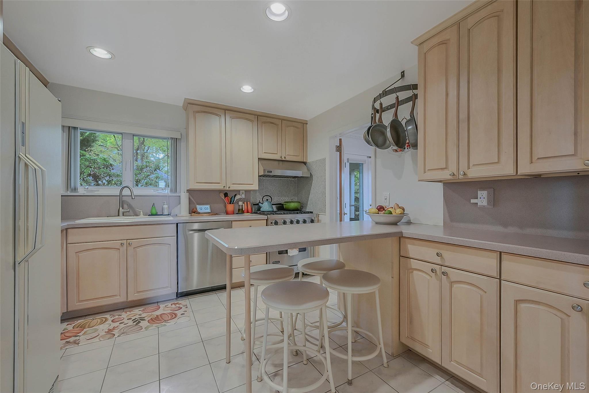746 Sound View Road Mill Neck, NY 11765 - Photo 14 of 37 a kitchen with white cabinets and white appliances