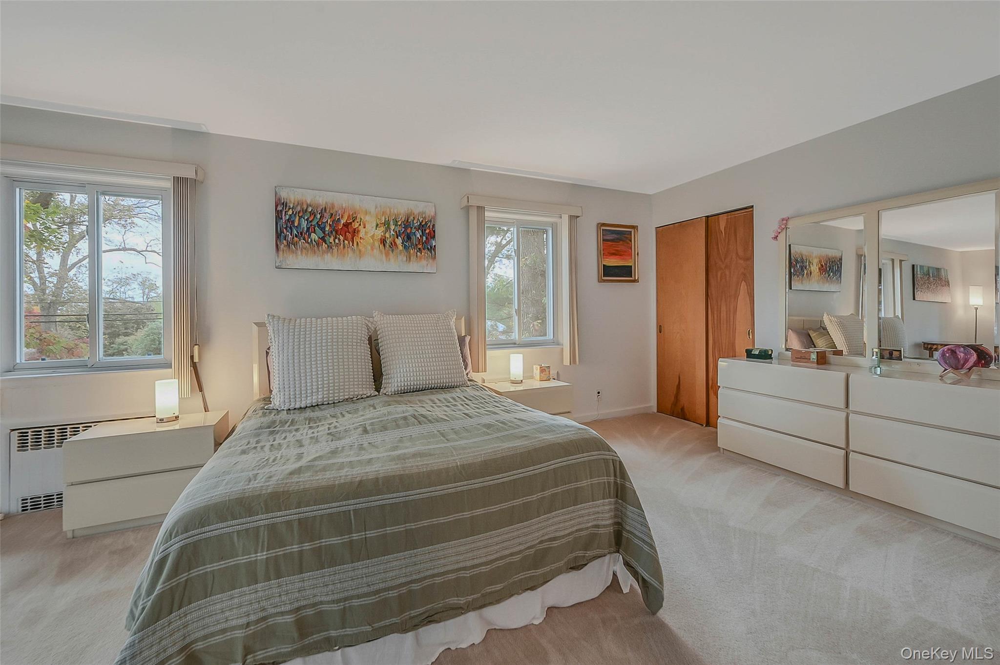 746 Sound View Road Mill Neck, NY 11765 - Photo 16 of 37 a spacious bedroom with a large bed and a couch