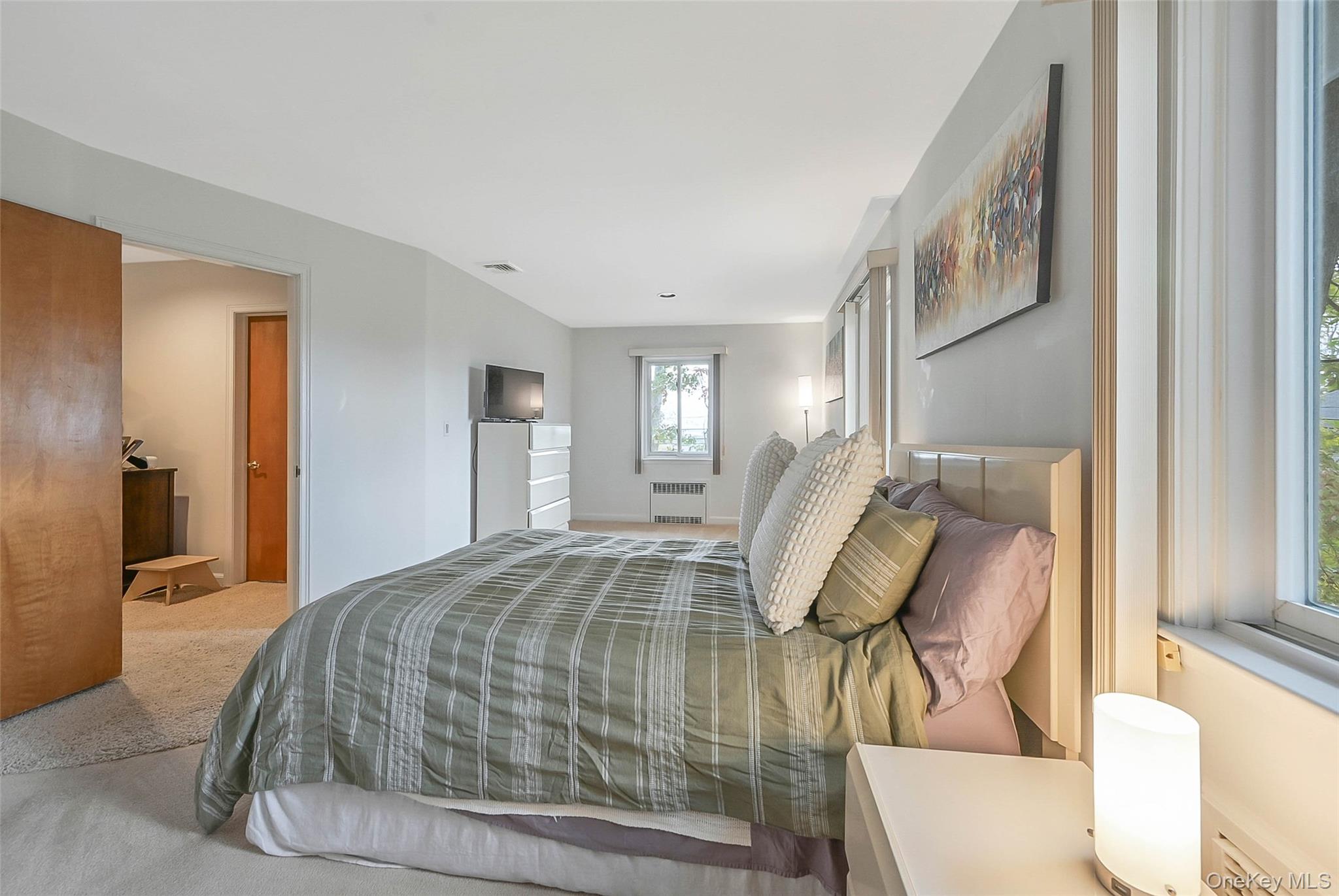 746 Sound View Road Mill Neck, NY 11765 - Photo 18 of 37 a bedroom with a bed and a mirror