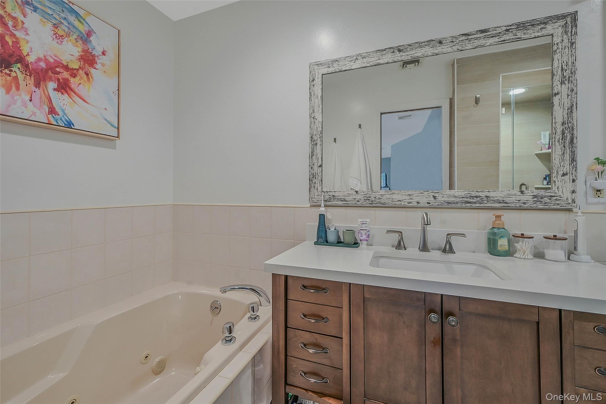 746 Sound View Road Mill Neck, NY 11765 - Photo 20 of 37 a bathroom with a tub a sink and mirror