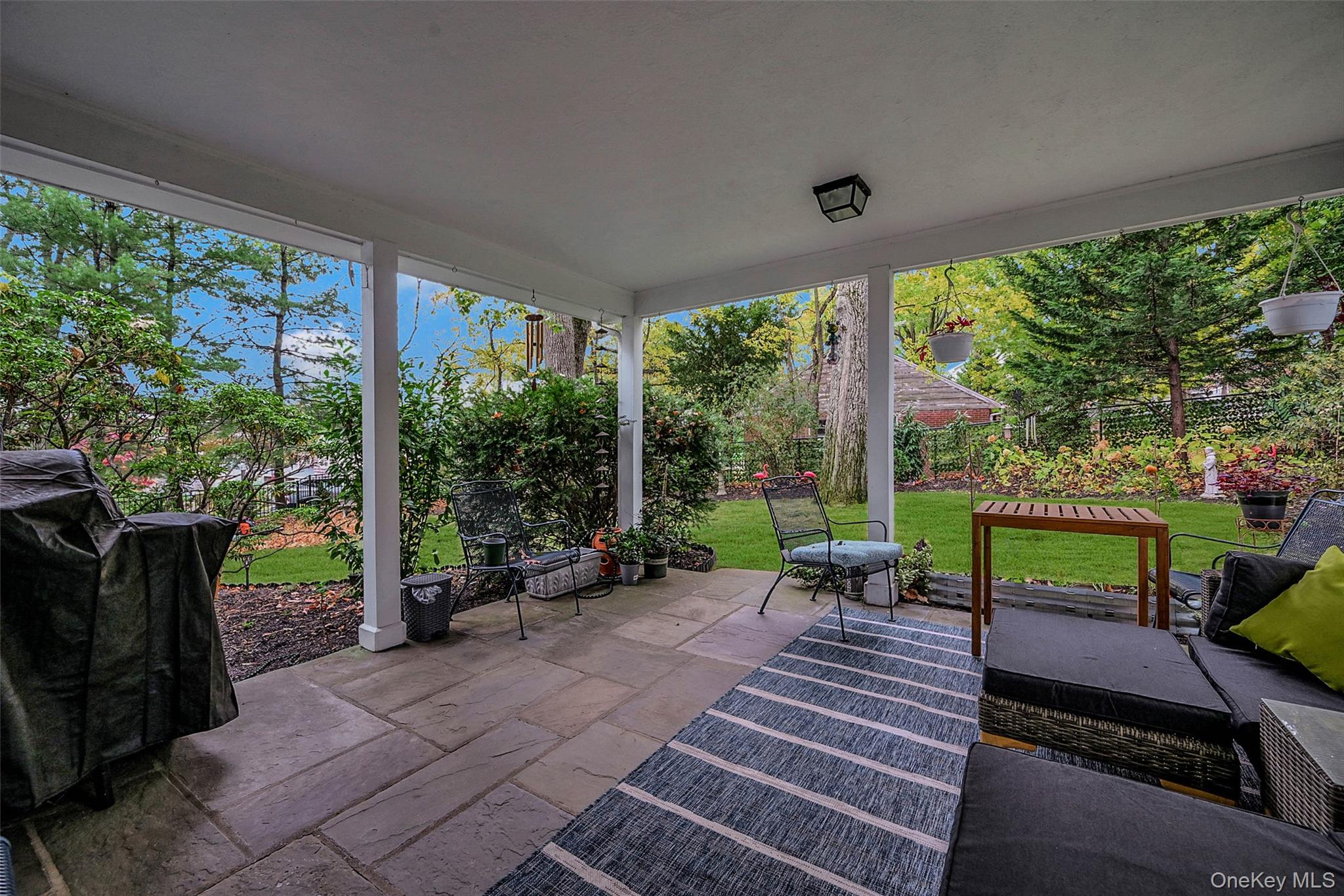 746 Sound View Road Mill Neck, NY 11765 - Photo 28 of 37 a view of a patio with a table chairs and a backyard