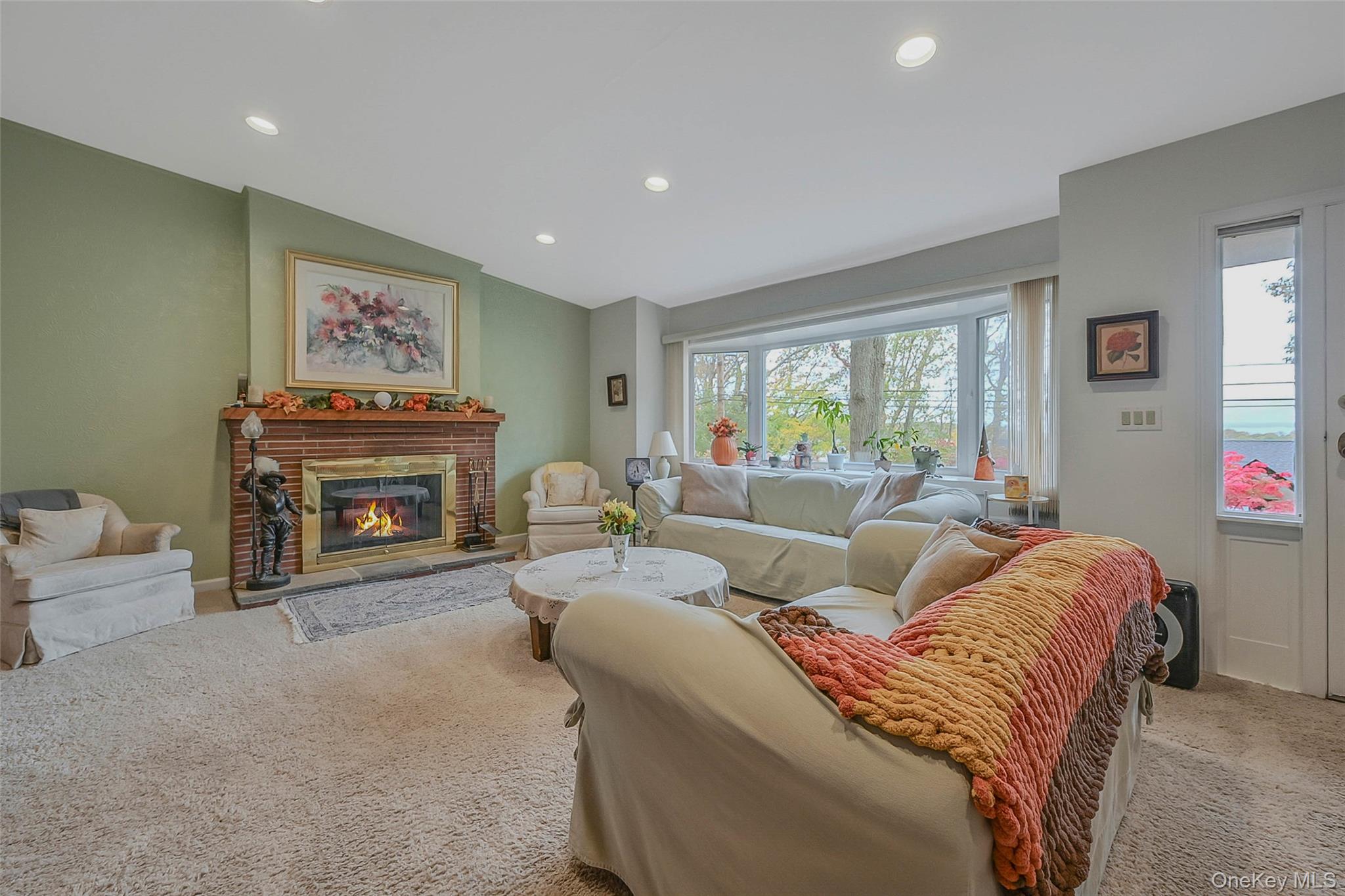 746 Sound View Road Mill Neck, NY 11765 - Photo 6 of 37 a living room with furniture a fireplace and a large window
