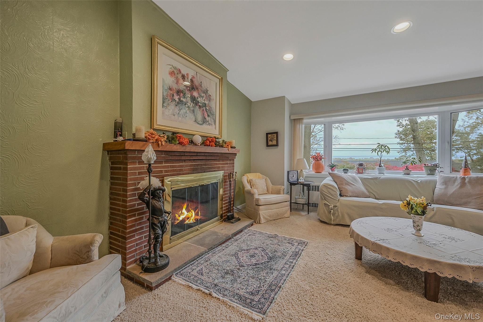 746 Sound View Road Mill Neck, NY 11765 - Photo 8 of 37 a living room with furniture a fireplace and a large window