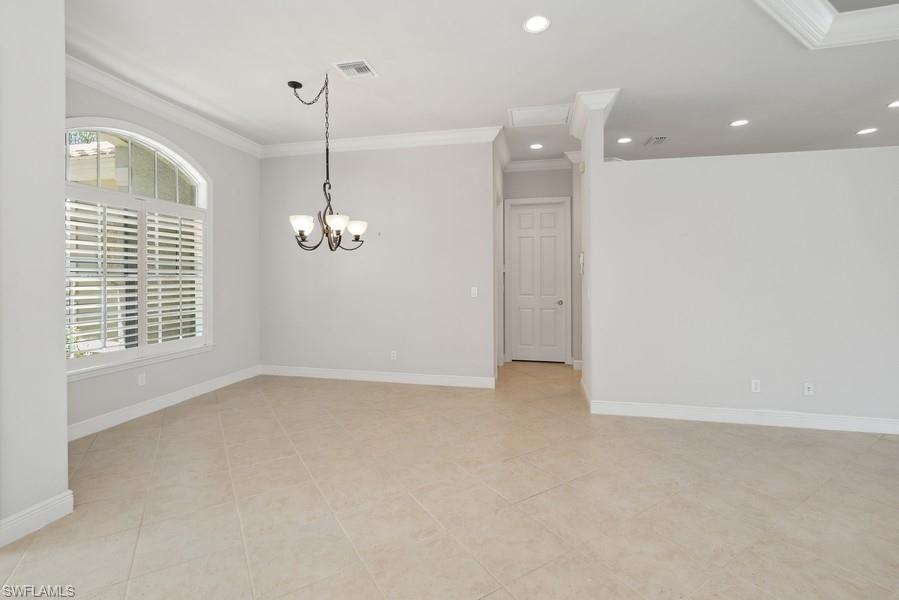 502 Cormorant Cove Naples, FL 34113 - Photo 11 of 25 an empty room with windows and entrance