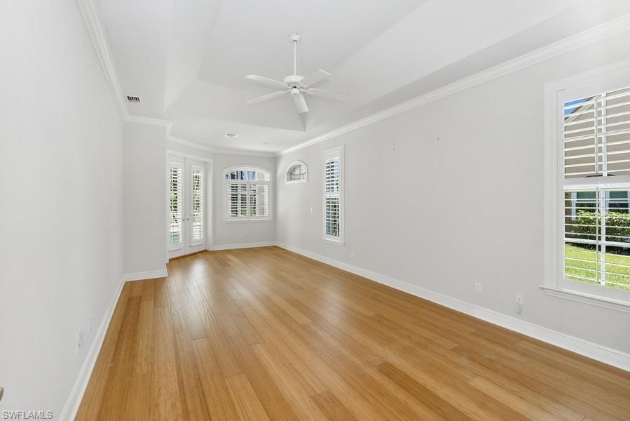 502 Cormorant Cove Naples, FL 34113 - Photo 14 of 25 wooden floor in an empty room with a window