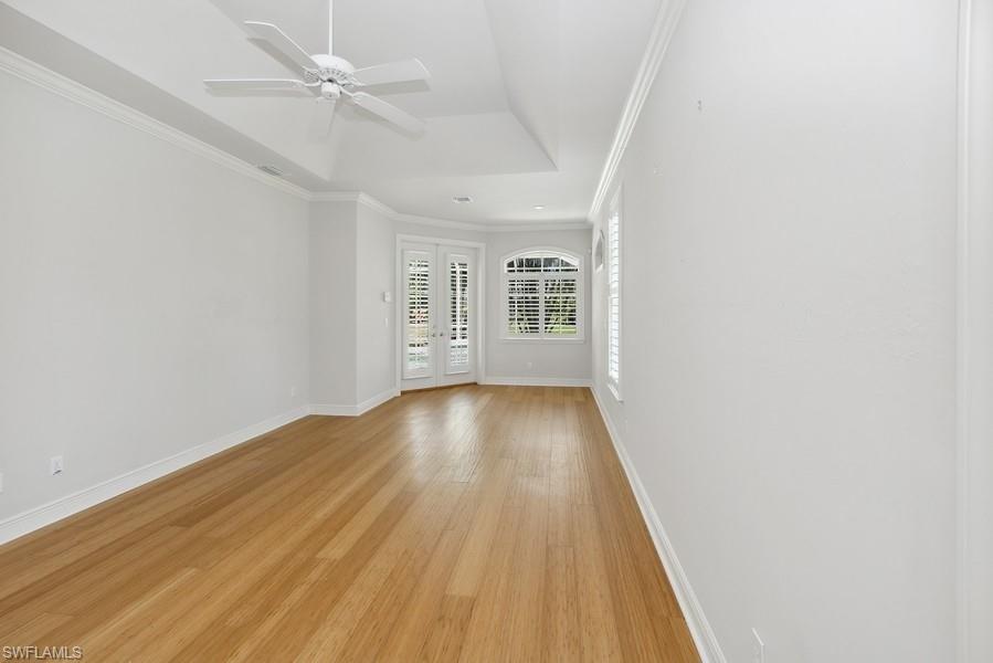 502 Cormorant Cove Naples, FL 34113 - Photo 15 of 25 wooden floor in an empty room with a window
