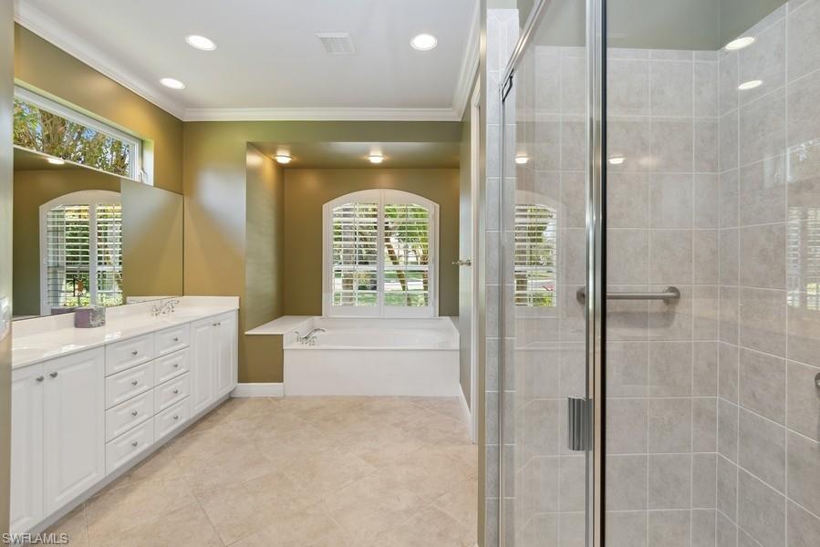 502 Cormorant Cove Naples, FL 34113 - Photo 16 of 25 a bathroom with a double vanity sink mirror and shower