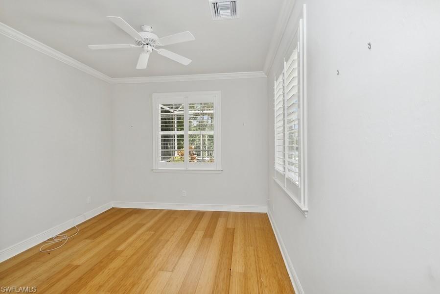 502 Cormorant Cove Naples, FL 34113 - Photo 19 of 25 an empty room with a window and ceiling fan