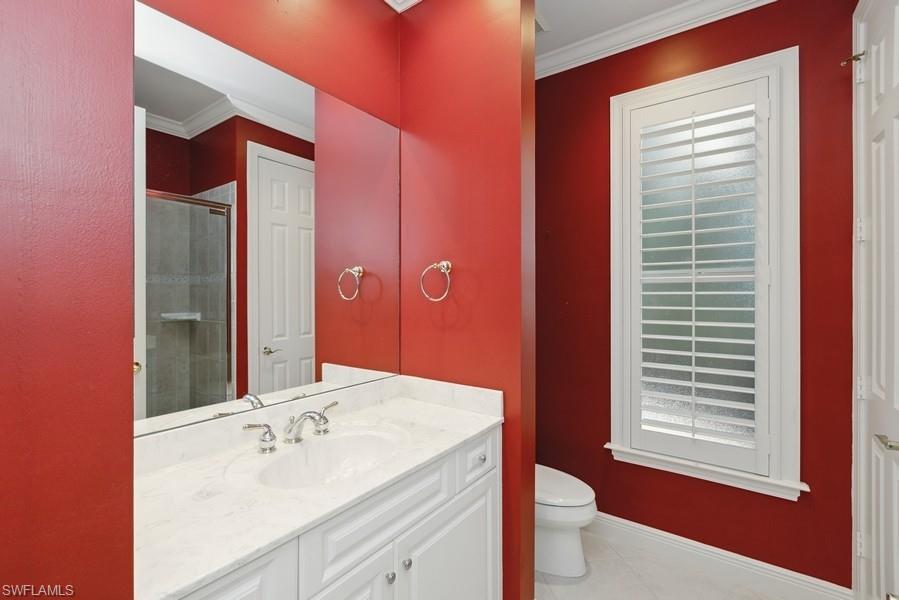 502 Cormorant Cove Naples, FL 34113 - Photo 21 of 25 a bathroom with a sink a toilet and shower