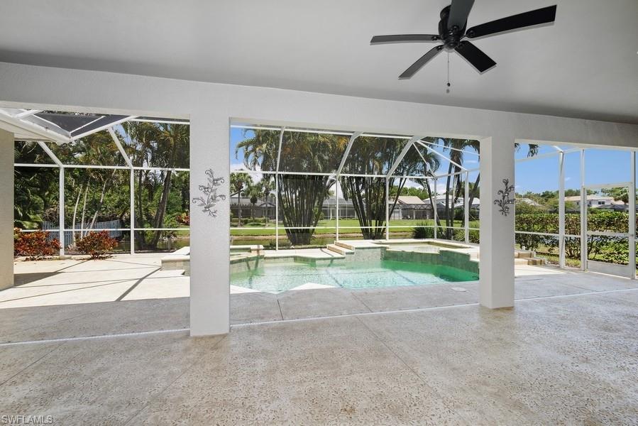502 Cormorant Cove Naples, FL 34113 - Photo 22 of 25 a view of an empty room with wooden floor and a floor to ceiling window