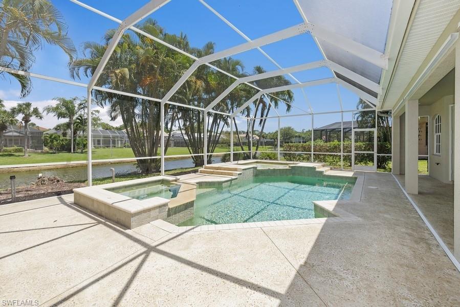 502 Cormorant Cove Naples, FL 34113 - Photo 23 of 25 a view of a backyard with a swimming pool