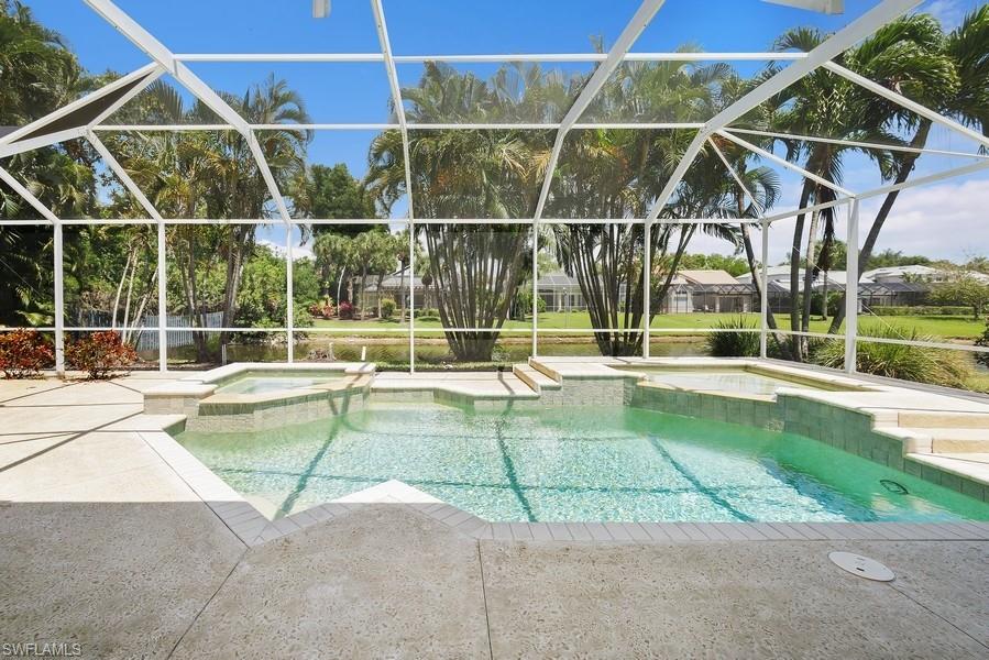 502 Cormorant Cove Naples, FL 34113 - Photo 24 of 25 a view of a backyard with a swimming pool