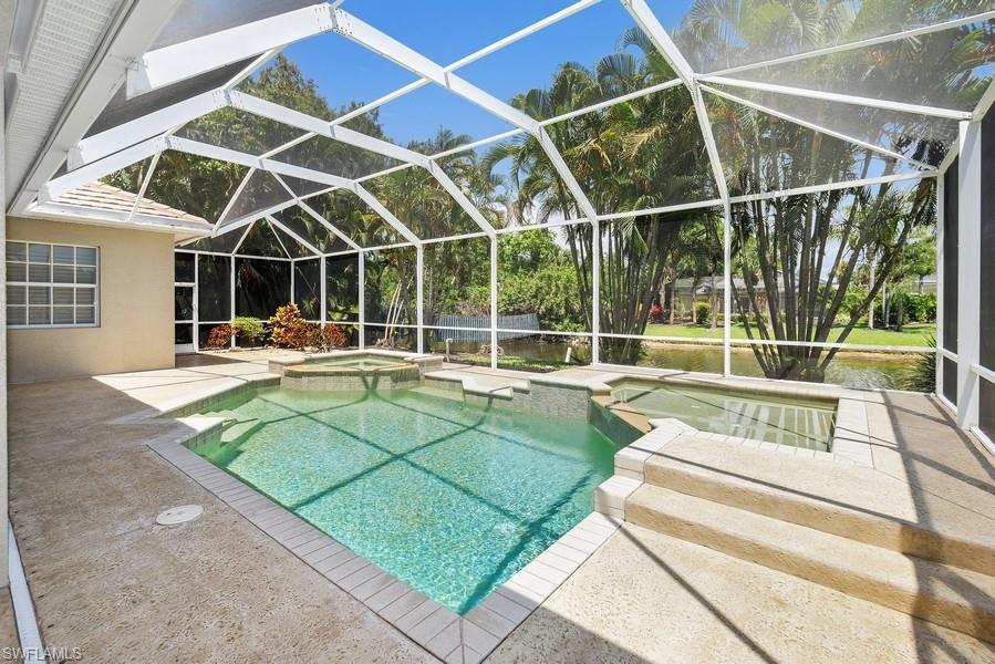 502 Cormorant Cove Naples, FL 34113 - Photo 25 of 25 a view of a backyard with a swimming pool