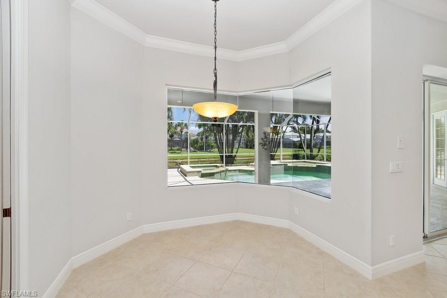 502 Cormorant Cove Naples, FL 34113 - Photo 10 of 25 a view of a room with window table and chairs