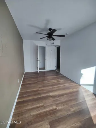 a view of wooden floor and windows in a room