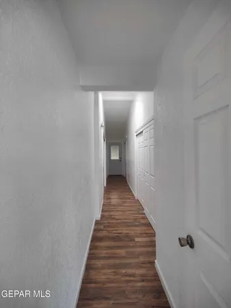a view of hallway with wooden floor