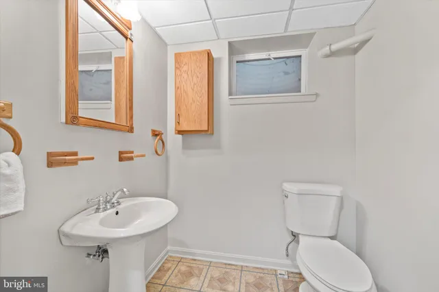 a bathroom with a sink mirror and toilet