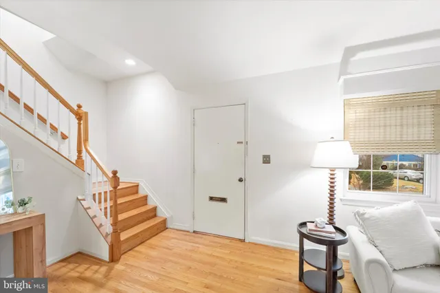 a view of entryway and hall with wooden floor