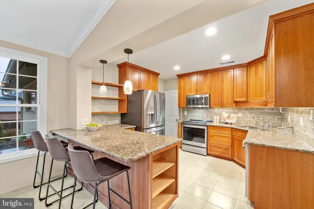 a kitchen with granite countertop kitchen island cabinets and refrigerator