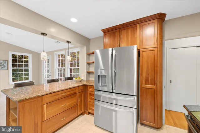 a kitchen with stainless steel appliances granite countertop a refrigerator and a sink